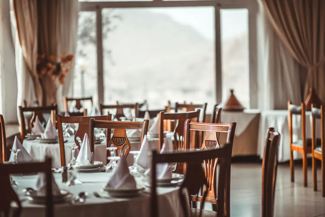 A dining room with tall windows